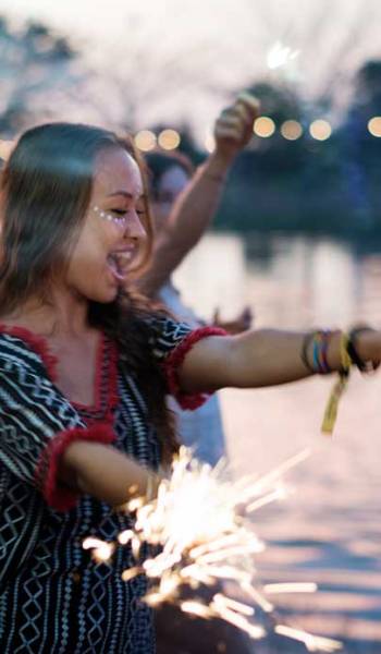 woman-enjoying-sparkler-in-festival-event-PR5RT45